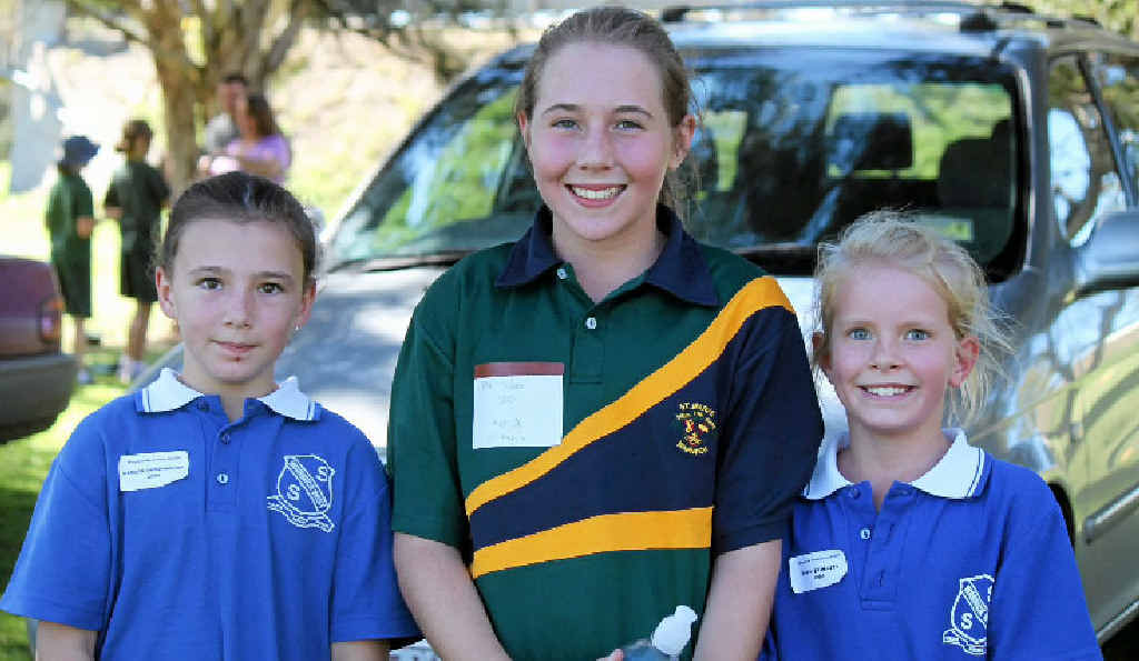 From left are Madison Ammenhauser in second place, Ella Hudson in first place and Sophie Follett in third for the 11 years girls cross country.